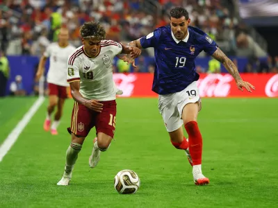 Soccer Football - FIFA World Cup 2026 - Semi Final - France v Spain - Dallas Stadium, Arlington, Texas, U.S. - July 14, 2026 Spain's Lamine Yamal in action with France's Theo Hernandez REUTERS/Hannah Mckay