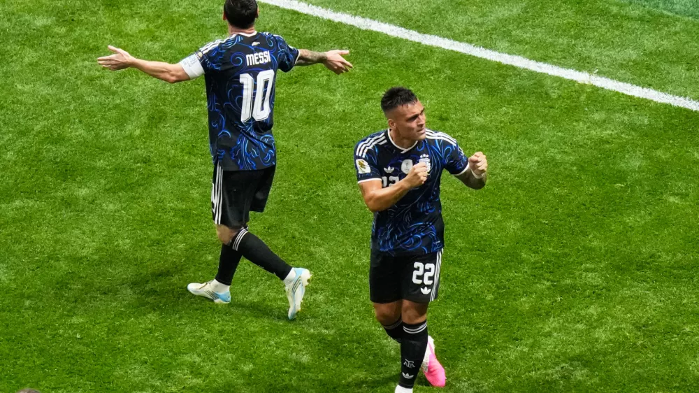 Argentina's Lautaro Martinez (22) and Lionel Messi (10) celebrate after defeating England in the World Cup semifinal soccer match in Atlanta, Wednesday, July 15, 2026. (AP Photo/Lynne Sladky)
