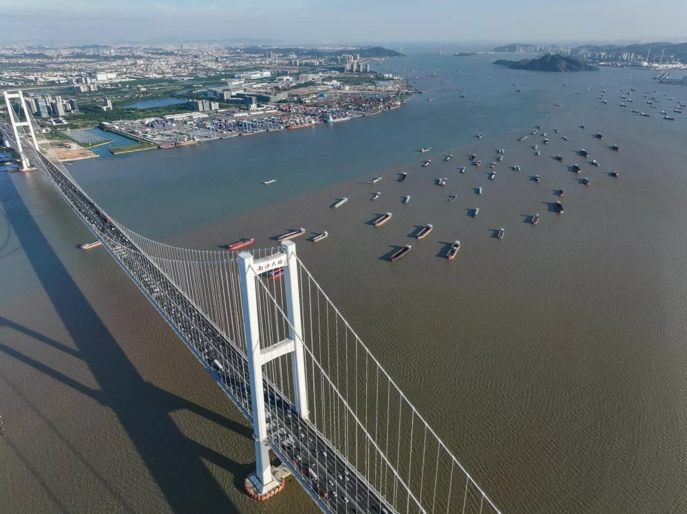 GUANGZHOU, Dec. 10, 2024 -- An aerial drone photo taken on Oct. 2, 2024 shows a view of the Nansha Bridge, which links Guangzhou City and Dongguan City, and ships along the Shiziyang channel in the Pearl River Estuary area, in south China's Guangdong Province. In recent years, the construction of cross-river and cross-sea passages in the Guangdong-Hong Kong-Macao Greater Bay Area has developed rapidly. The passage networks play a significant role in building and improving the comprehensive three-dimensional transportation network in the Greater Bay Area, as well as promoting deeper integration and development in the region.,Image: 915775405, License: Rights-managed, Restrictions:, Model Release: no