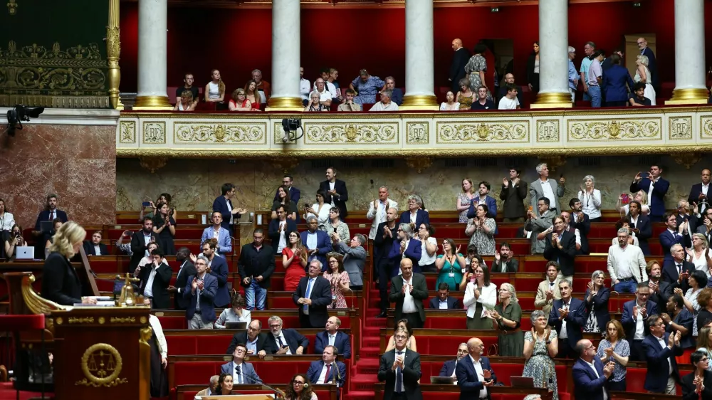 Members of parliament applaud following the result of a vote on the bill establishing a right to medical aid in dying at the National Assembly in Paris, France, July 15, 2026. REUTERS/Abdul Saboor