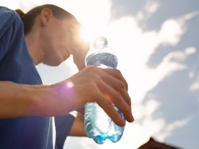 Woman drinking water in extreme summer heat wave. / Foto: Kieferpix Getty Images