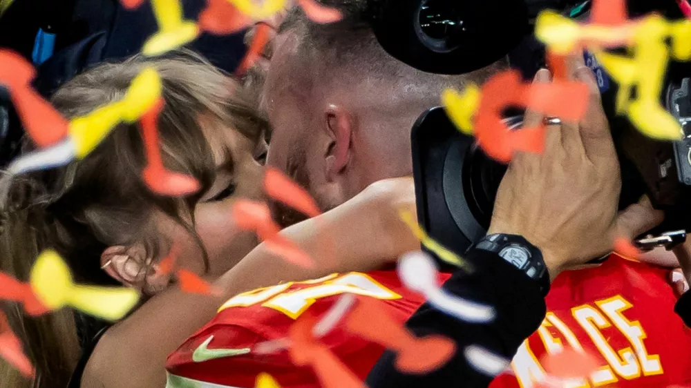 FILE PHOTO: Football - NFL - Super Bowl LVIII - Kansas City Chiefs v San Francisco 49ers - Allegiant Stadium, Las Vegas, Nevada, United States - February 11, 2024 Kansas City Chiefs' Travis Kelce kisses partner Taylor Swift as they celebrate after Kansas City Chiefs win Super Bowl LVIII REUTERS/Carlos Barria/File Photo
