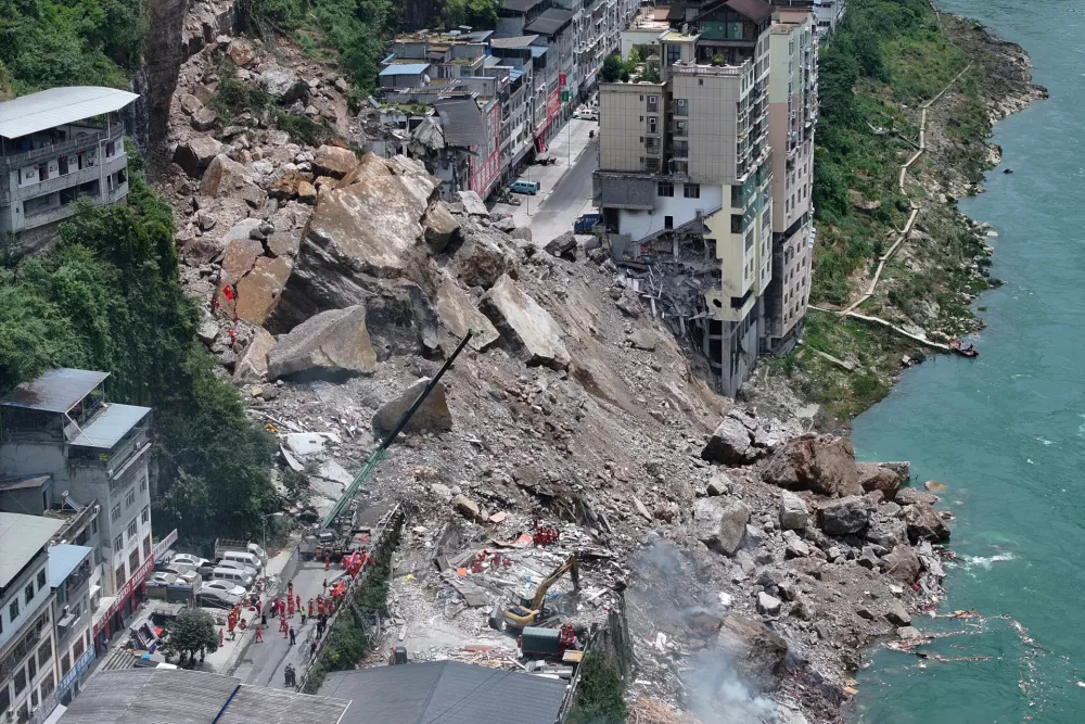 In this photo released by Xinhua News Agency, rescuers conduct search and rescue operation on the site of the landslide in Pengshui County in southwestern China's Chongqing on Friday, July 17, 2026. (Wang Quanchao/Xinhua via AP)