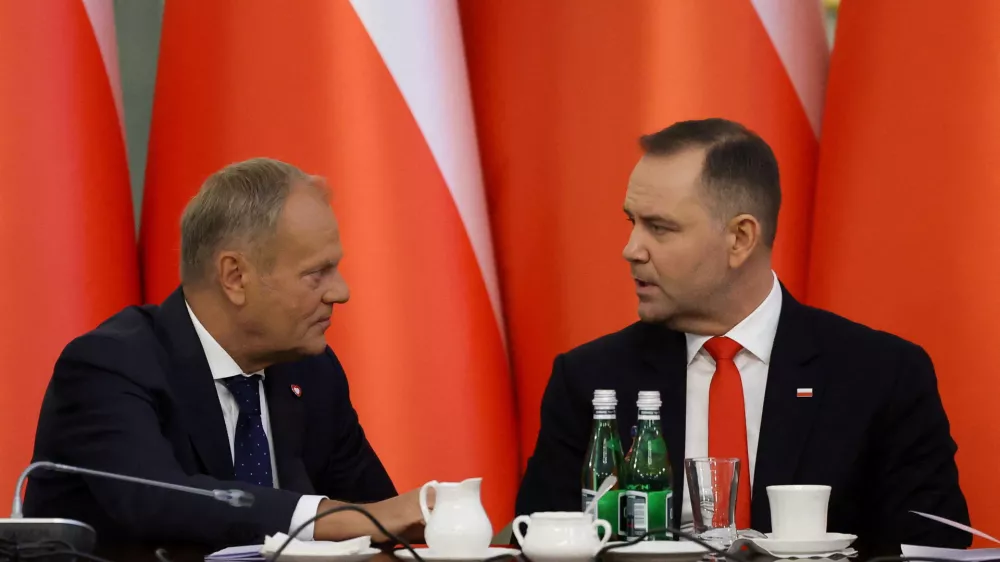 FILE PHOTO: Poland's Prime Minister Donald Tusk speaks to President Karol Nawrocki during a Cabinet Council meeting led by the president at the Presidential Palace in Warsaw, Poland, August 27, 2025. REUTERS/Kacper Pempel/File Photo