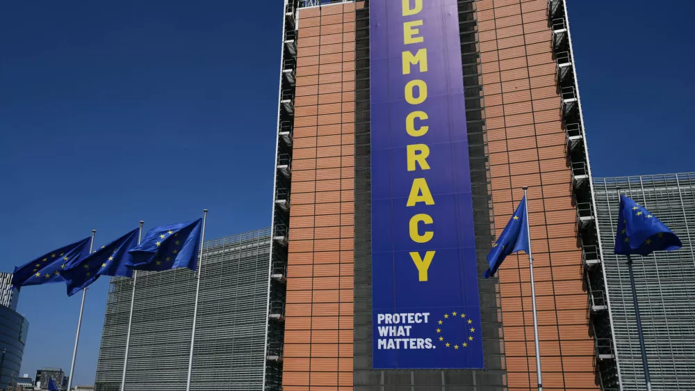 Visitors wait in line to get into an open house to celebrate Europe Day at EU headquarters in Brussels, Saturday, May 9, 2026. (AP Photo/Virginia Mayo)
