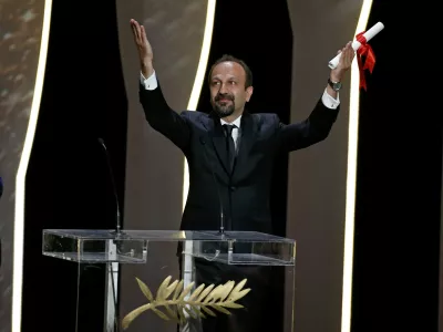 Director Asghar Farhadi, Best screenplay award winner for his film "Forushande" (The Salesman), reacts on stage during the closing ceremony of the 69th Cannes Film Festival in Cannes, France, May 22, 2016.      REUTERS/Eric Gaillard