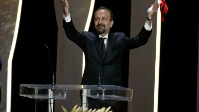 Director Asghar Farhadi, Best screenplay award winner for his film "Forushande" (The Salesman), reacts on stage during the closing ceremony of the 69th Cannes Film Festival in Cannes, France, May 22, 2016.      REUTERS/Eric Gaillard