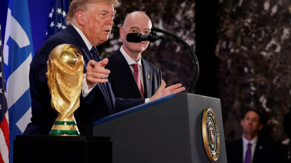 U.S. President Donald Trump, flanked by FIFA President Gianni Infantino, gestures while speaking next to FIFA World Cup Trophy, as they attend a FIFA reception at Trump Tower in New York City, U.S., July 17, 2026. REUTERS/Evan Vucci   TPX IMAGES OF THE DAY