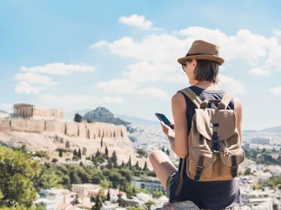 Young woman traveler using mobile phone outdoor