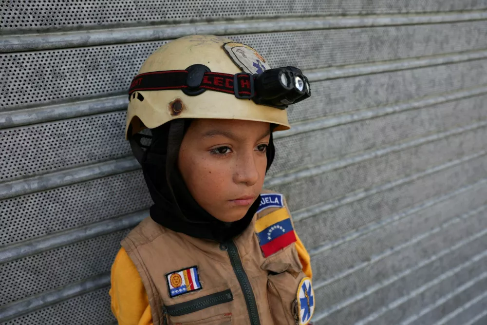 Sebastian Corro, 10 years old, who is taking part in search and rescue efforts in the aftermath of the June 24 earthquakes, poses for a picture, in La Guaira state, Venezuela, July 17, 2026. REUTERS/Gaby Oraa   TPX IMAGES OF THE DAY
