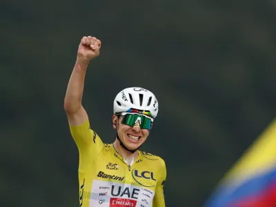Cycling - Tour de France - Stage 14 - Mulhouse to Le Markstein Fellering - Le Markstein Fellering, France - July 18, 2026 UAE Team Emirates XRG's Tadej Pogacar, wearing the yellow jersey, celebrates after winning stage 14 REUTERS/Gonzalo Fuentes