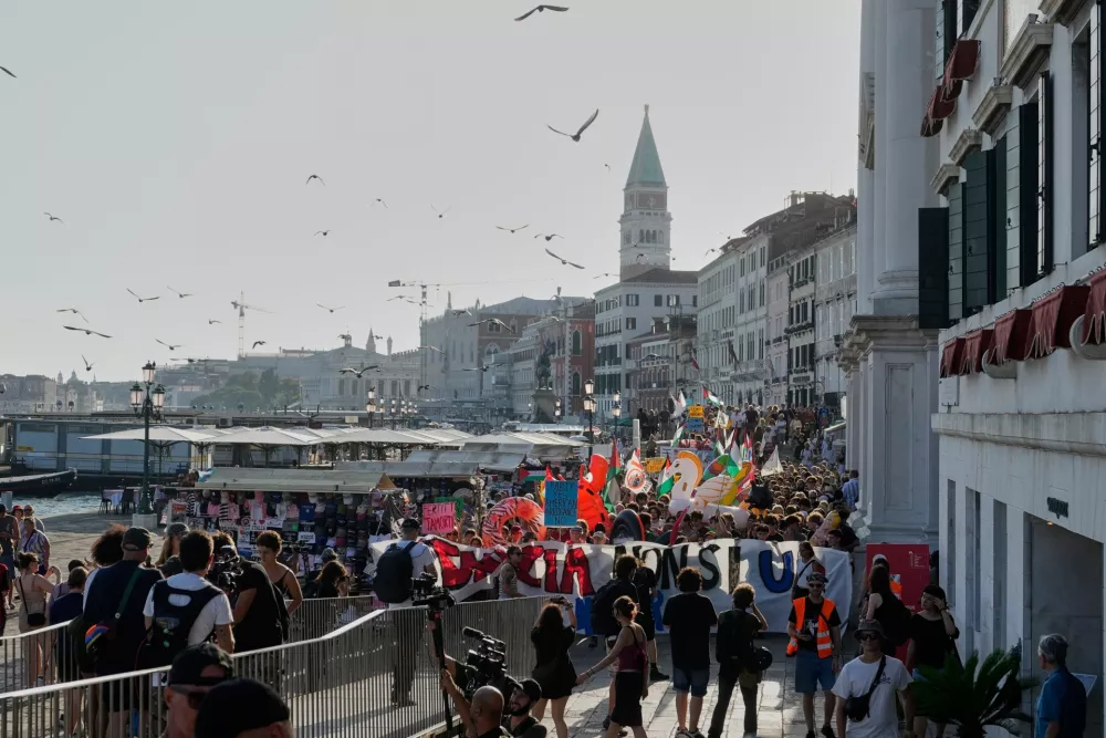 Demonstrators gather to protest against U.S. Ambassador Tilman Fertitta's superyacht 'Boardwall' presence in Venice, Friday, July 17, 2026. (AP Photo/Luca Bruno)
