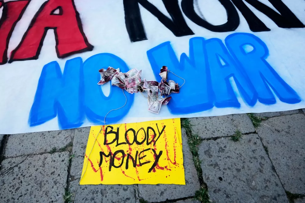 Banners placed by demonstrators are seen during a protest against U.S. Ambassador Tilman Fertitta's superyacht 'Boardwall' presence in Venice, Friday, July 17, 2026. (AP Photo/Luca Bruno)