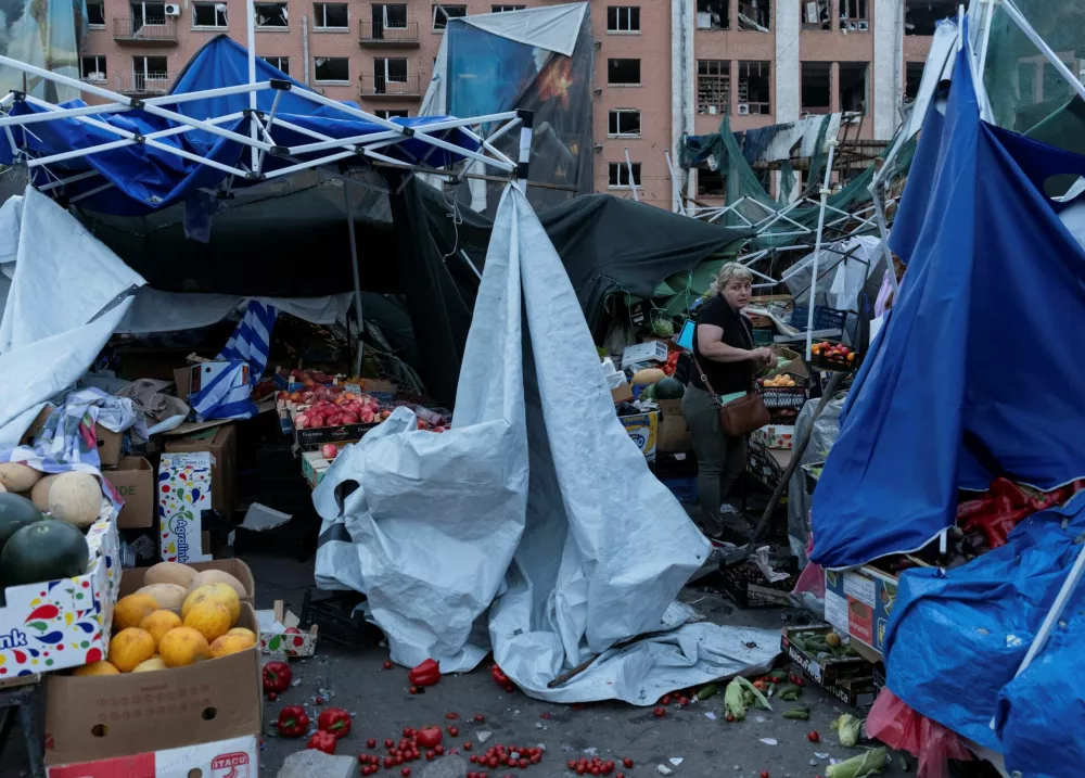 A market trader inspects damage to her stalls after a night of Russian missile strikes, amid Russia's attack on Ukraine, in Kyiv, Ukraine, July 19, 2026. REUTERS/Stringer
