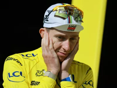 Cycling - Tour de France - Stage 15 - Champagnole to Plateau de Solaison - Plateau de Solaison, France - July 19, 2026 UAE Team Emirates XRG's Tadej Pogacar reacts on the podium wearing the yellow jersey after stage 15 REUTERS/Stephanie Lecocq