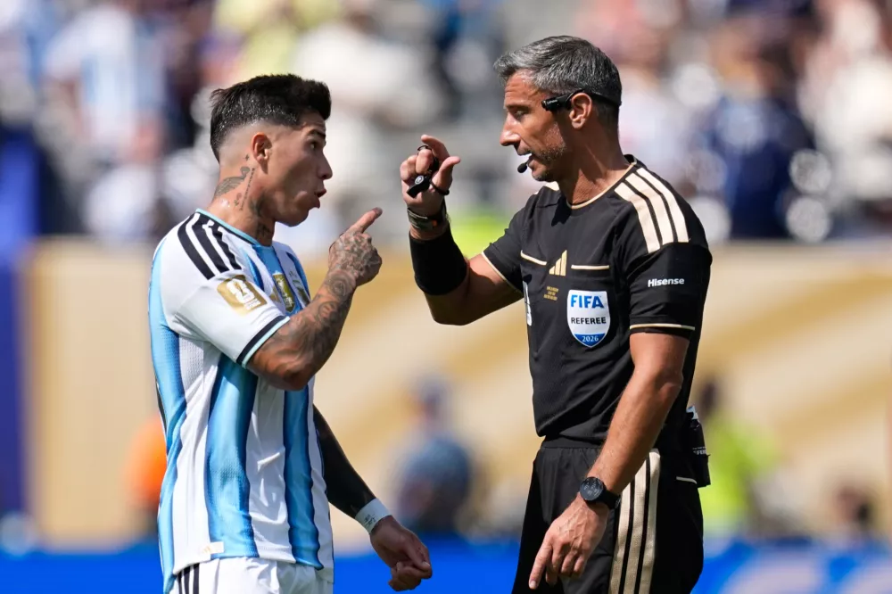 Argentina's Enzo Fernandez speaks to Referee Slavko Vincic, of Slovenia, during the World Cup final soccer match between Spain and Argentina in East Rutherford, N.J., near New York, Sunday, July 19, 2026. (AP Photo/Ashley Landis)