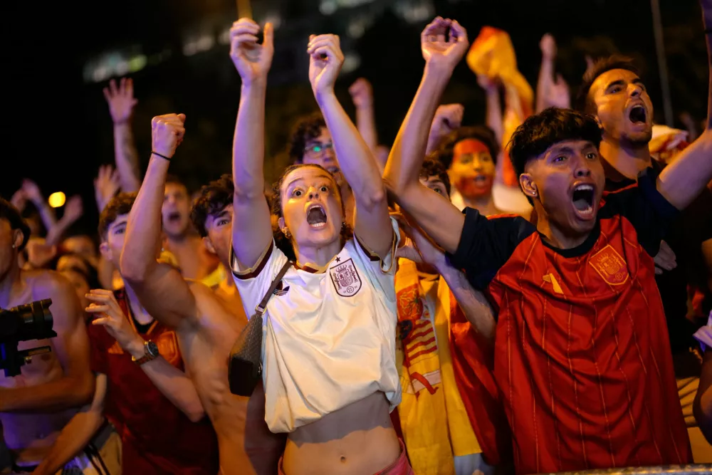 Spanish fans react while watching the World Cup final soccer match between Spain and Argentina on giant screens in central Madrid, Sunday, July 19, 2026. The match is being played in East Rutherford, N.J., near New York. (AP Photo/Bernat Armangue)