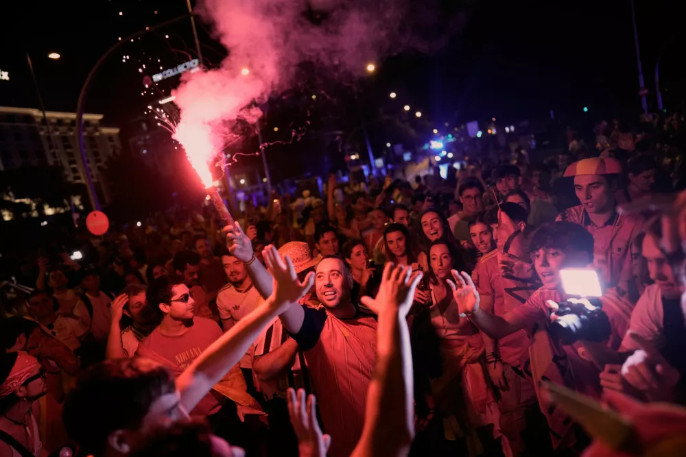 Spanish fans celebrate in central Madrid after Spain defeated Argentina in the World Cup final soccer match in East Rutherford, N.J., near New York, Sunday, July 19, 2026. (AP Photo/Bernat Armangue)