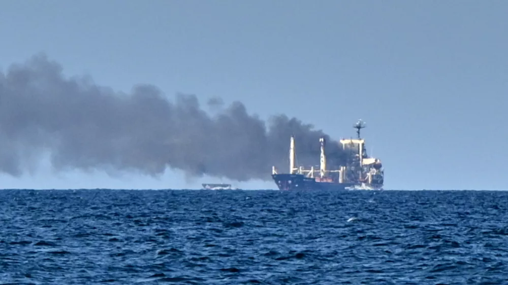 Smoke rises from the grain carrier Golden Leo&nbsp;under the Guinea-Bissau flag after Russian missile strike in the Black Sea close to Odesa, Ukraine, Sunday, July 19, 2026, local media reports. (AP Photo/Michael Shtekel)