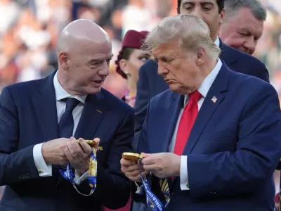 FIFA President Gianni Infantino, left, and President Donald Trump comment on the medals as they wait to congratulate the Spanish players after the World Cup final soccer match between Spain and Argentina in East Rutherford, N.J., near New York, Sunday, July 19, 2026. (AP Photo/Jacquelyn Martin)