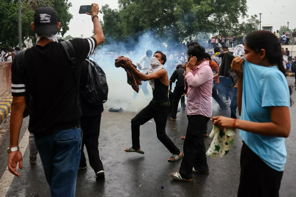 Supporters of India's Cockroach Janta Party react to tear gas during a march on parliament on the opening day of its monsoon session, demanding the resignation of Education Minister Dharmendra Pradhan over exam paper leaks, in New Delhi, India, 20 July, 2026. REUTERS/Anushree Fadnavis