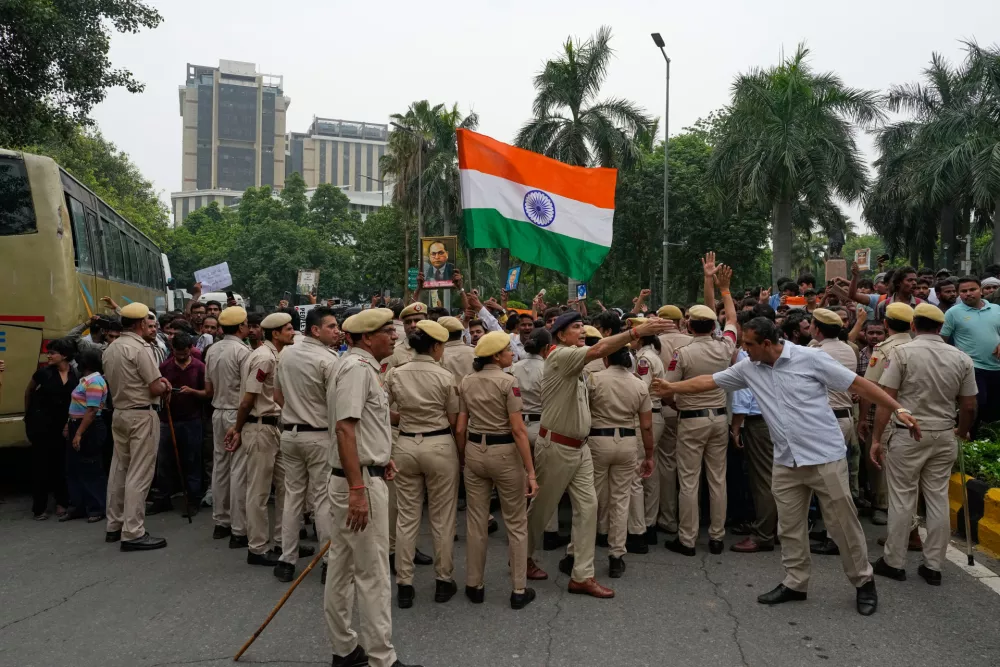 Police stop supporters of the Cockroach Janta Party as they attempt to march toward India's Parliament, demanding the resignation of the education minister, in New Delhi, India, Monday, July 20, 2026.(AP Photo/Manish Swarup)