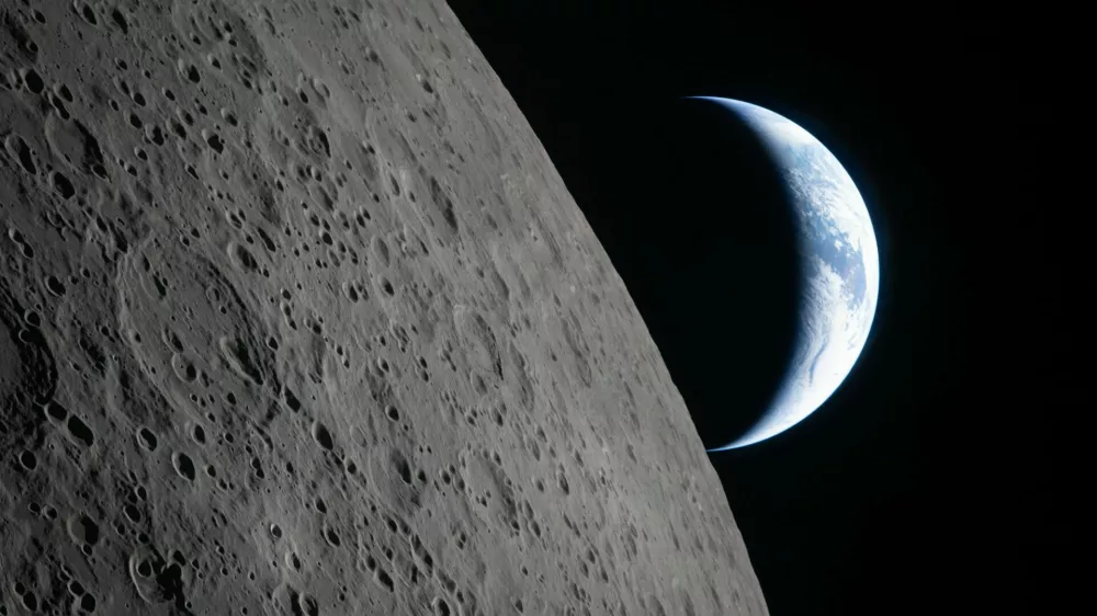 In this image provided by NASA, the Artemis II crew captured this view as the Earth sets behind the Moon during a lunar flyby, Monday, April 6, 2026. (NASA via AP)