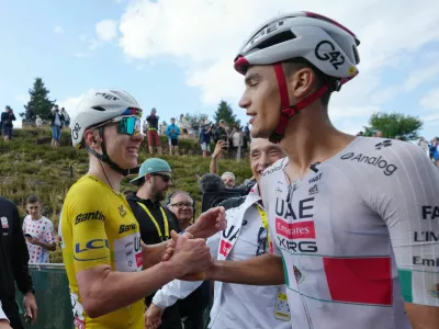 Cycling - Tour de France - Stage 14 - Mulhouse to Le Markstein Fellering - Le Markstein Fellering, France - July 18, 2026 UAE Team Emirates XRG's Tadej Pogacar, wearing the yellow jersey, celebrates with teammate UAE Team Emirates XRG's Isaac Del Toro after winning stage 14 Pool via REUTERS/Thibault Camus