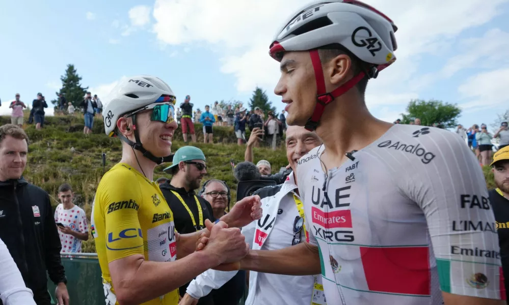 Cycling - Tour de France - Stage 14 - Mulhouse to Le Markstein Fellering - Le Markstein Fellering, France - July 18, 2026 UAE Team Emirates XRG's Tadej Pogacar, wearing the yellow jersey, celebrates with teammate UAE Team Emirates XRG's Isaac Del Toro after winning stage 14 Pool via REUTERS/Thibault Camus