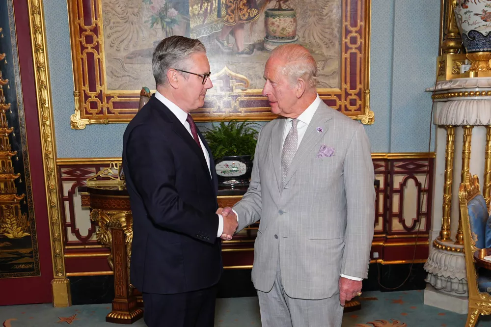 Britain's King Charles III welcomes outgoing Prime Minister Keir Starmer, during an audience at Buckingham Palace in London, Monday July 20, 2026. (Aaron Chown/Pool Photo via AP)