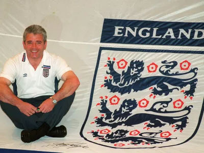 FILE PHOTO: Football - England Team Squad Annoucement - Metropole Hotel - 15/5/00 Mandatory Credit: Action Images / John Sibley England's manager Kevin Keegan poses with with a giant England Shirt which will be used by the fans/File Photo