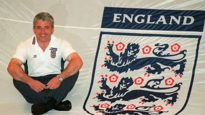 FILE PHOTO: Football - England Team Squad Annoucement - Metropole Hotel - 15/5/00 Mandatory Credit: Action Images / John Sibley England's manager Kevin Keegan poses with with a giant England Shirt which will be used by the fans/File Photo