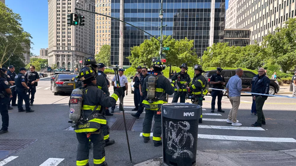 The New York City Fire Department and law enforcement respond to an incendiary device outside the New York federal building in lower Manhattan, Monday, July 20, 2026, in New York. (AP Photo/Larry Neumeister)