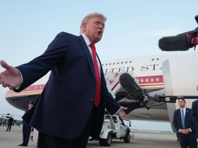 President Donald Trump speaks to reporters as he exits Air Force One at Joint Base Andrews, Md., after attending the World Cup final soccer match, Sunday, July 19, 2026. (AP Photo/Jacquelyn Martin)