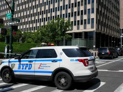 An NYPD police vehicle stands parked outside 26 Federal Plaza, which houses the FBI's New York City field office and the Immigration and Customs Enforcement (ICE) field office, following reports that a person deployed an incendiary device, in New York City, U.S., July 20, 2026. REUTERS/David Dee Delgado