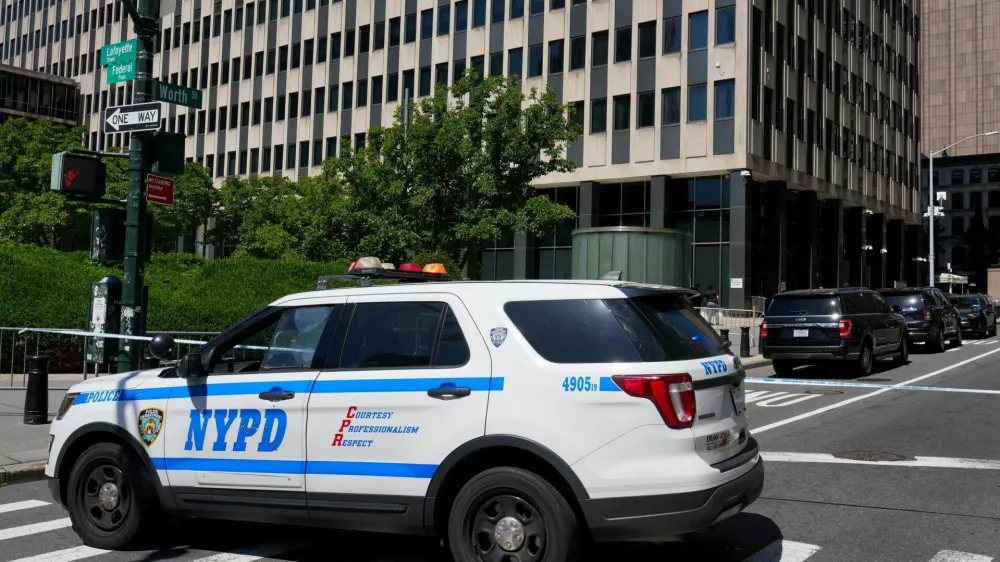 An NYPD police vehicle stands parked outside 26 Federal Plaza, which houses the FBI's New York City field office and the Immigration and Customs Enforcement (ICE) field office, following reports that a person deployed an incendiary device, in New York City, U.S., July 20, 2026. REUTERS/David Dee Delgado
