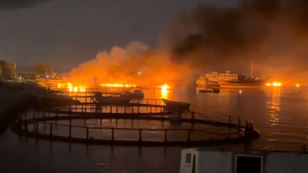 Smoke rises from a port, near Strait of Hormuz, following a U.S. strike in Kuhestak, Hormozgan Province, Iran, July 8, 2026, in this screengrab obtained from a social media video. Social Media/via REUTERS THIS IMAGE HAS BEEN SUPPLIED BY A THIRD PARTY. MANDATORY CREDIT. NO RESALES. NO ARCHIVES. NEWS USE ONLY. Verification line: Reuters confirmed the location by matching the port layout visible in the video with satellite imagery. The coordinates are 26.801109802855272, 57.02121784040872. The date the video was filmed was verified through a report from Iran's semi-official Mehr News Agency, which reported explosions early on July 8 at multiple locations along the Gulf coast, including Kuhestak. Aftermath photographs shared online on July 8 also showed damage at the same location. No earlier versions of the footage or photographs posted before July 8 were found.
