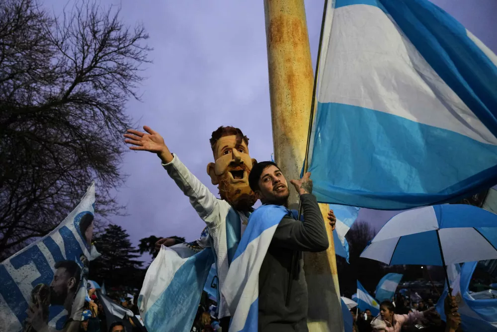 An Argentina fan wearing a mask depicting Lionel Messi gathers outside the Argentine Football Association headquarters while waiting for the national team to arrive in Ezeiza, on the outskirts of Buenos Aires, Monday, July 20, 2026, following its World Cup final loss to Spain. (AP Photo/Rodrigo Abd)