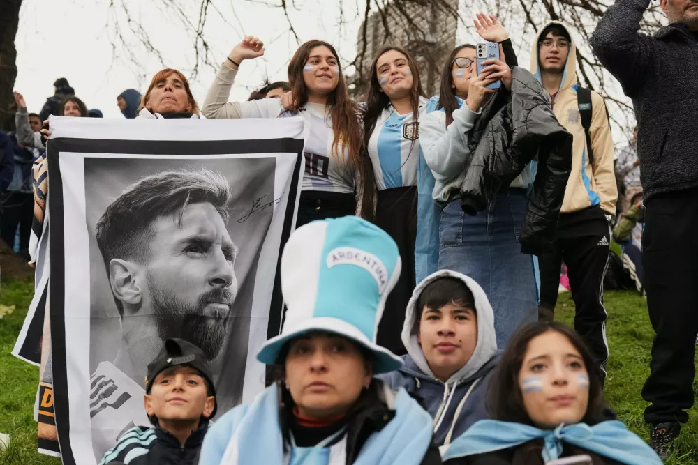Argentina fans hold a photo of Lionel Messi as they gather outside the Argentine Football Association headquarters and wait for the national team to arrive in Ezeiza, on the outskirts of Buenos Aires, Monday, July 20, 2026, following its World Cup final loss to Spain. (AP Photo/Gustavo Garello)
