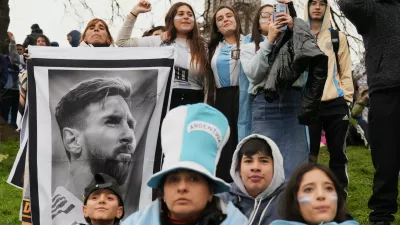 Argentina fans hold a photo of Lionel Messi as they gather outside the Argentine Football Association headquarters and wait for the national team to arrive in Ezeiza, on the outskirts of Buenos Aires, Monday, July 20, 2026, following its World Cup final loss to Spain. (AP Photo/Gustavo Garello)