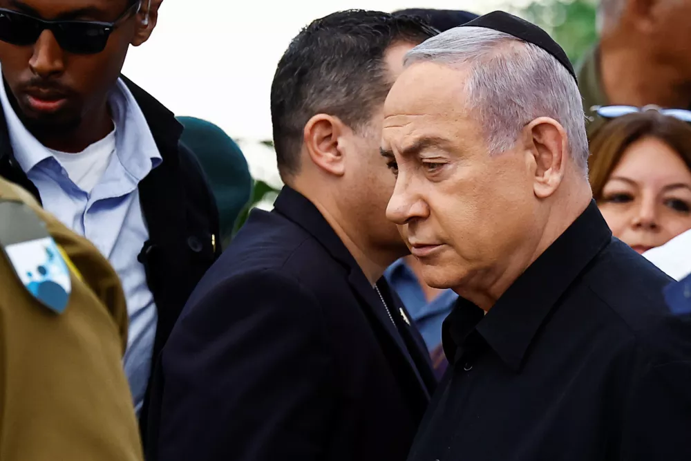 Israeli Prime Minister Benjamin Netanyahu attends the funeral of Gal Meir Eisenkot, 25, an Israeli solider and the son of Israeli cabinet minister and former military chief Gadi Eizenkot, who was killed in northern Gaza during the ongoing ground operation by Israel's military in the Gaza Strip, in Herzliya, Israel, December 8, 2023. REUTERS/Clodagh Kilcoyne