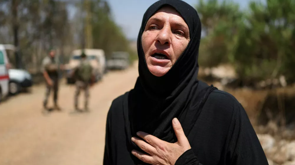 A villager waits at the entrance of her village, Zawtar al-Gharbiyeh, in southern Lebanon as Lebanese soldiers deploy in the area following the withdrawal of Israeli forces under a U.S.-brokered plan, July 21, 2026. REUTERS/Zohra Bensemra