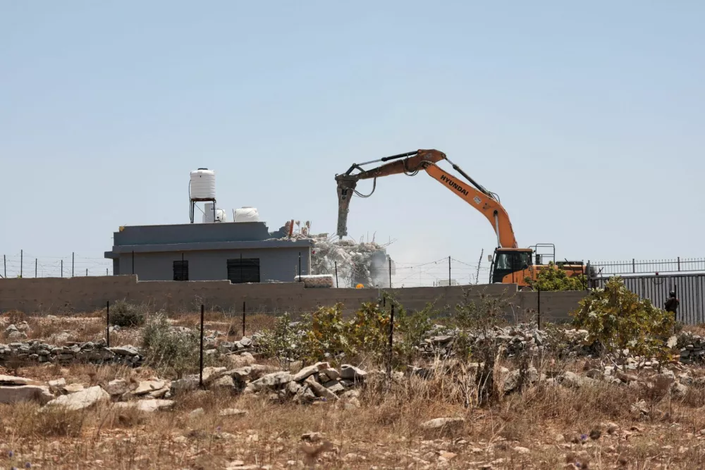 Israeli forces use machinery to demolish a Palestinian house near Ramallah, in the Israeli-occupied West Bank, July 22, 2026. REUTERS/Mohammed Torokman