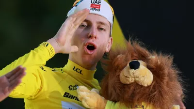 Cycling - Tour de France - Stage 21 - Paris, France - July 26, 2026 UAE Team Emirates XRG's Tadej Pogacar celebrates on the podium while wearing the yellow jersey after winning the Tour de France REUTERS/Stephanie Lecocq   TPX IMAGES OF THE DAY