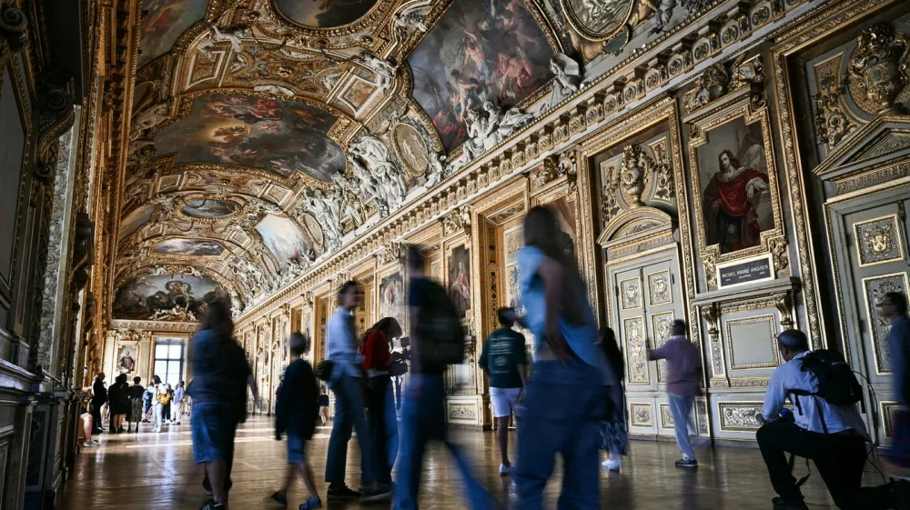 Visitors arrive during the reopening to the public of the Apollo Gallery, where French crown jewels worth 88 million euros were stolen in 2025 in a brazen heist, at the Mus&eacute;e du Louvre in Paris on July 22, 2026.,Image: 1117855123, License: Rights-managed, Restrictions:, Model Release: no 