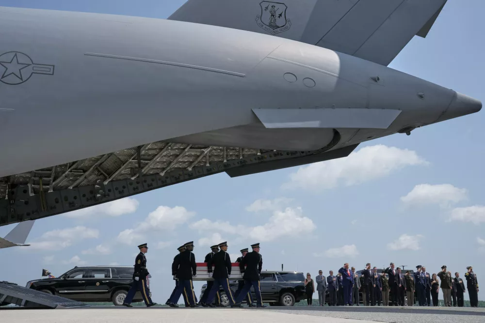 President Donald Trump, Secretary of Defense Pete Hegseth and others, salute as a U.S. Army carry team moves a transfer case containing the remains of Pvt. Isabella Gonzales of Carrollton, Texas, Wednesday, July 22, 2026, at Dover Air Force Base, Del. (AP Photo/Matt Rourke)
