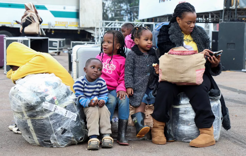 Ugandan nationals gather with their luggage to be documented after arriving, as authorities repatriate citizens fleeing xenophobic attacks in South Africa, at the Kololo ceremonial grounds in Kampala, Uganda, July 20, 2026. REUTERS/Michael Muhati  TPX IMAGES OF THE DAY