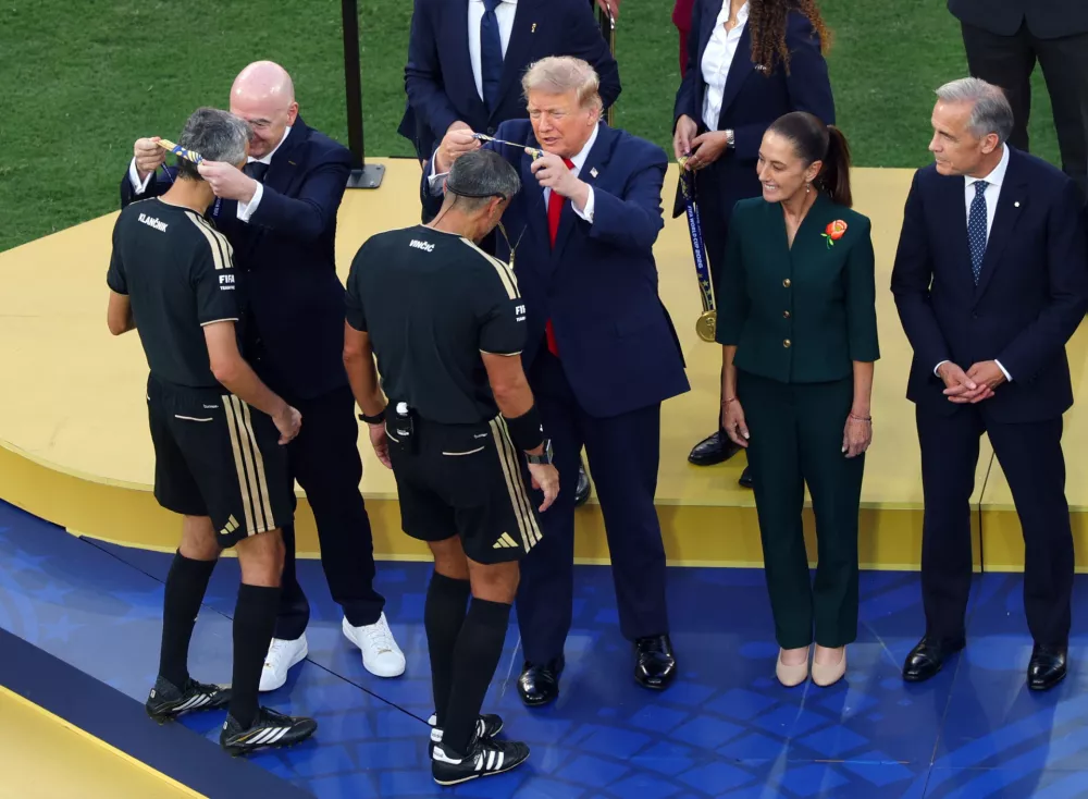 Soccer Football - FIFA World Cup 2026 - Final - Spain v Argentina - New York/New Jersey Stadium, East Rutherford, New Jersey, U.S. - July 19, 2026 Referee Slavko Vincic is awarded a medal by U.S. President Donald Trump after the match REUTERS/Mike Segar