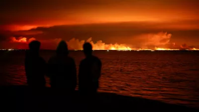 Tourists watch a wildfire burn in a forest area near the Arcachon Bay from Gujan-Mestras, in the Gironde department, amid worsening drought conditions following a heatwave and water shortages across much of France, July 24, 2026. REUTERS/Stephane Mahe   TPX IMAGES OF THE DAY