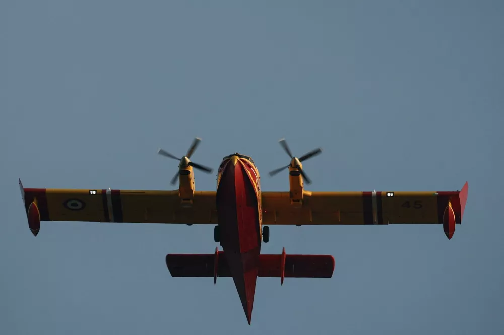 A Canadair firefighting aircraft flies over a wildfire near Cotignac, in the Var department amid worsening drought conditions following a heatwave and water shortages across much of the country, France, July 23, 2026. REUTERS/Manon Cruz